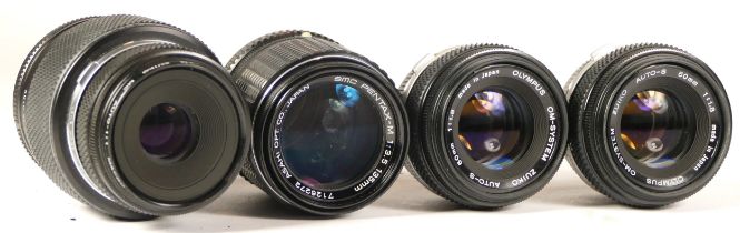 Four camera lenses comprising two Olympus 50mm lenses (each working with dust specks and faint