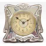 An Edwardian hallmarked silver mounted and oak strut cartouche shaped mantle clock, hallmarked for