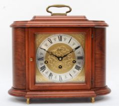 A 20th century Rapport walnut cased cartouche shaped striking mantle clock, with swing carrying