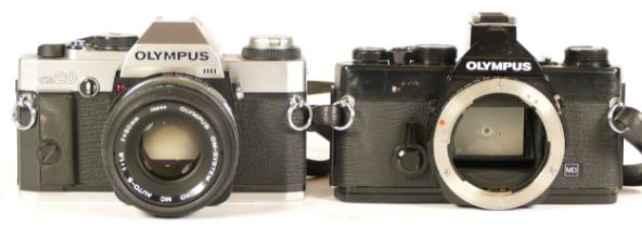 Two Olympus cameras comprising of Olympus OM-1N MD All Black camera (working) together with an