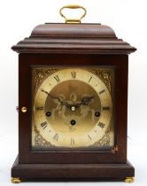 A contemporary Comitti mahogany cased mantle clock, with brass sing handle, the engraved brass