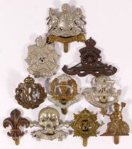 Ten military cap badges, including Royal Flying Corps and Manchester Regt