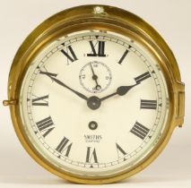 A Smiths Empire brass bulkhead clock, circa 1950s, 17cm diameter.