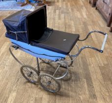 A 1970s Wilson pram with cream body and brown covers.