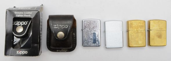 Four Zippo cigarette lighters, pocket petrol filled, together with two Zippo leather lighter