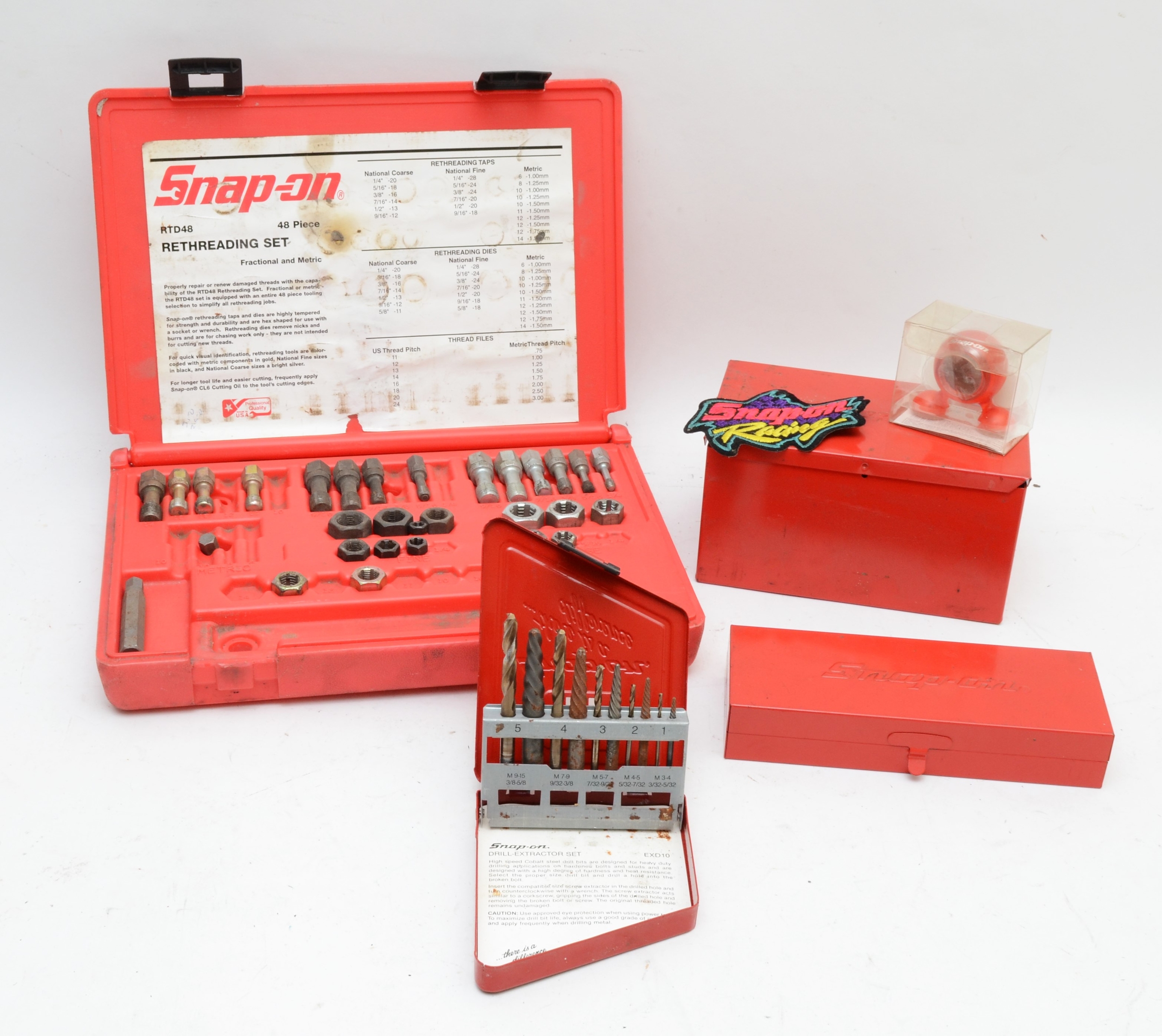 Snap-on drill extractor set, a part rethreading kit and two metal boxes