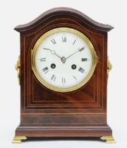 An Edwardian inlaid mahogany mantle arch topped mantle fusee mantle clock, with twin lion mask swing