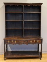 A George III and later adapted oak dresser, with open shelf back raised on twin drawer base with