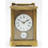 An early 20th century brass and four glass corniche cased striking carriage clock, the white