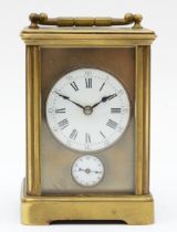 An early 20th century brass and four glass corniche cased striking carriage clock, the white