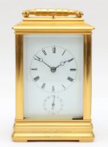 A late 19th century brass corniche cased and four glass presentation striking carriage clock, with