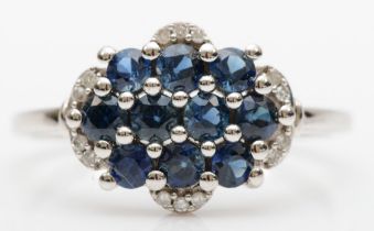 A 9ct white gold sapphire and eight cut diamond cluster ring, Q, 2.6gm.
