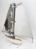 A mid 20th century Yacht shaped heater (element been removed), 67x68cm.