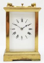 A 20th century French brass and four glass carriage clock, the white dial with black Roman