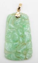 A 14k gold green jadeite floral carved pendant, 46 x 21mm, 11gm.