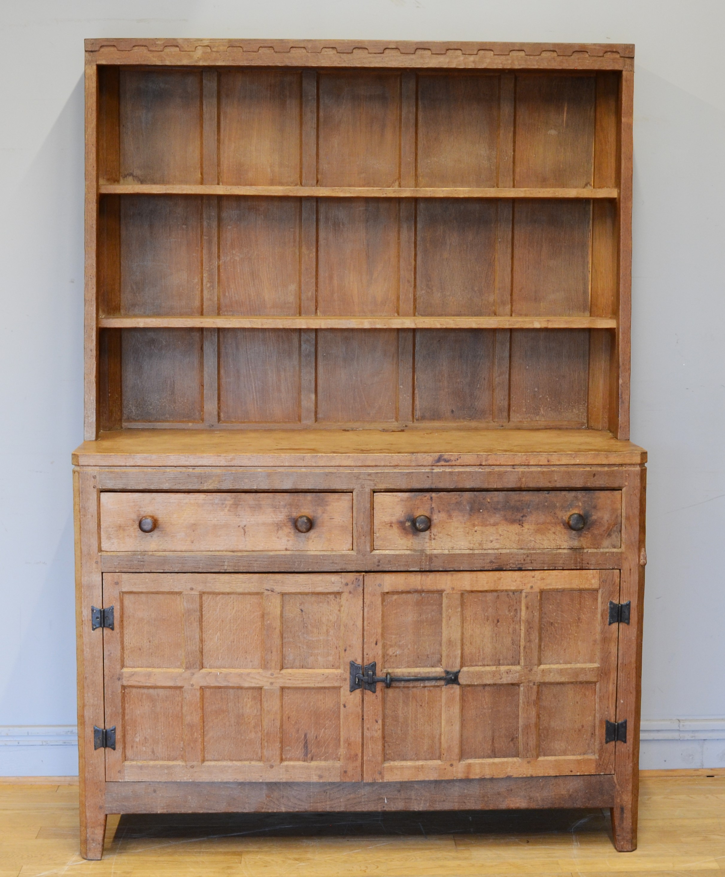 Peter 'Rabbitman' Heap, a mid 20th century adzed oak Welsh style dresser, the panelled upper section