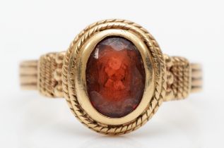 A vintage 9ct gold garnet dress ring, with rope twist and bead decoration, O, 3gm.