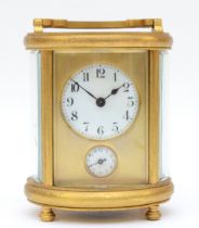 A 20th century oval brass cornice cased and four glass carriage clock, with swing handle, the