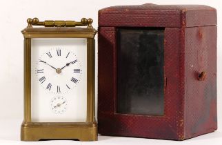 An early 20th century brass corniche cased and four glass carriage clock, with swing handle, the