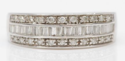 A 9ct white gold diamond half eternity ring, set with channel set baguette cut and eight cut