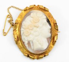 A Victorian 9ct gold shell cameo brooch depicting Flora, 3.5 x 3cm, with chased scrolling boarder,