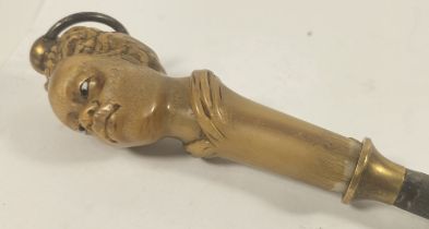 A 19th century carved Rhinoceros horn carving steel or poker, the handle in the form of an Afro Car