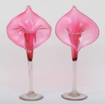 A pair of early 20th cranberry and clear glass Jack in the Pulpit style vases, each raised on