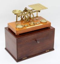 A set early 20th century mahogany cased oak and brass set of postal scales, complete with brass