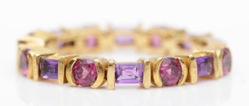 A 9kt gold garnet and amethyst articulated ring, P, 2.8gm.