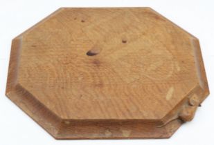 Robert 'Mouseman' Thompson of Kilburn, a 20th century oak octagonal chopping board with carved mouse