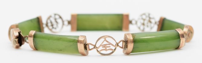 A 14k gold paneled nephrite bracelet, with Chinese character spacers, 18.5cm, 8gm.