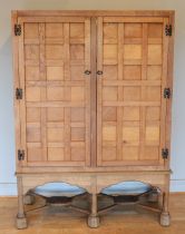 A 20th century carved oak twin panelled door cupboard (converted from a tallboy) the doors with