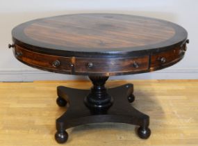 A 19th century Rosewood circular drum table, raised on central fluted urn support standing quad base