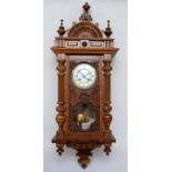 An early 20th century walnut cased Vienna style regulator eight day wall clock, the white dial