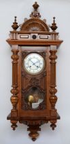 An early 20th century walnut cased Vienna style regulator eight day wall clock, the white dial