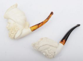 Two Meerschaum style pipes, each bowl carved with the head of a bearded gentleman, 15cm long.