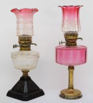 A 19th/early 20th century brass and glass oil lamp, with clear and cranberry glass shade etched with