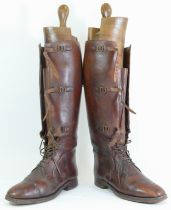 A pair of 20th century brown leather riding boots, with strapwork buckles and laces, 49cm high,