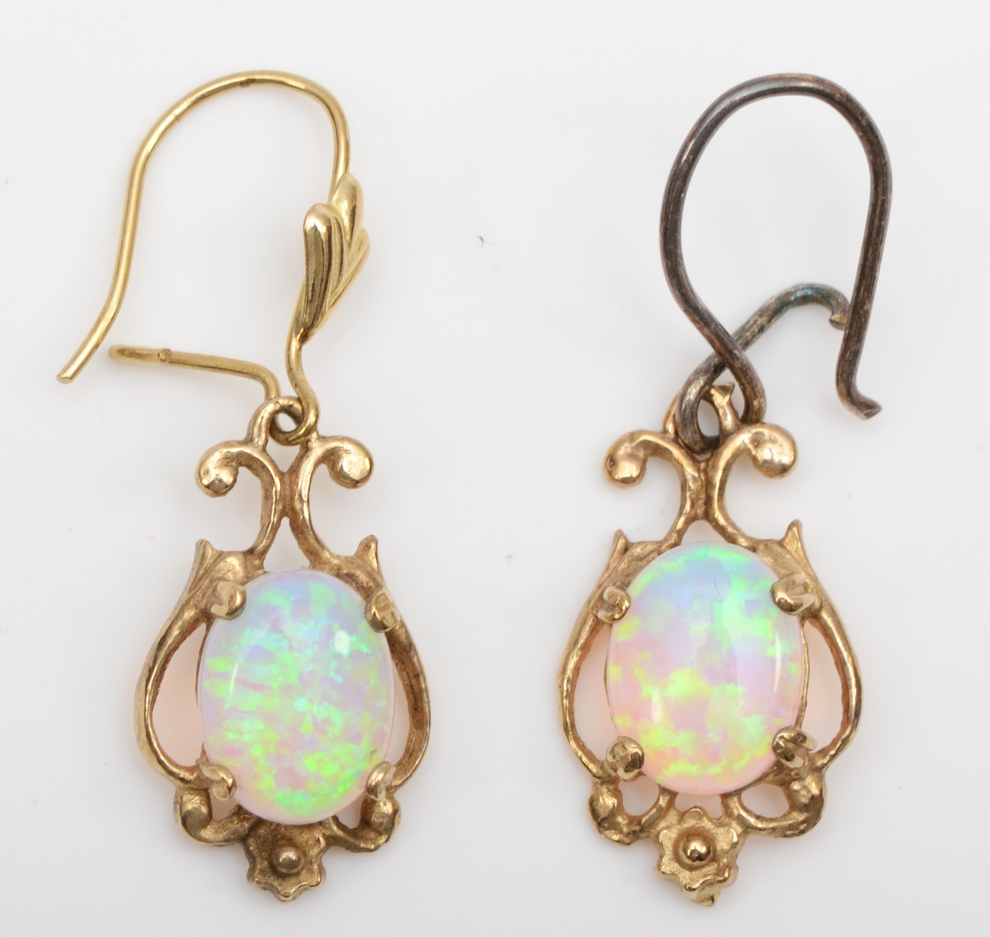 A pair of unmarked gold synthetic opal drop earrings, one with replaced silver post, 17mm, 2.2gm.