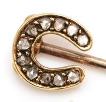 A Victorian unmarked gold horse shoe stick pin, set with mine cut diamonds, 5cm, 1.2gm.