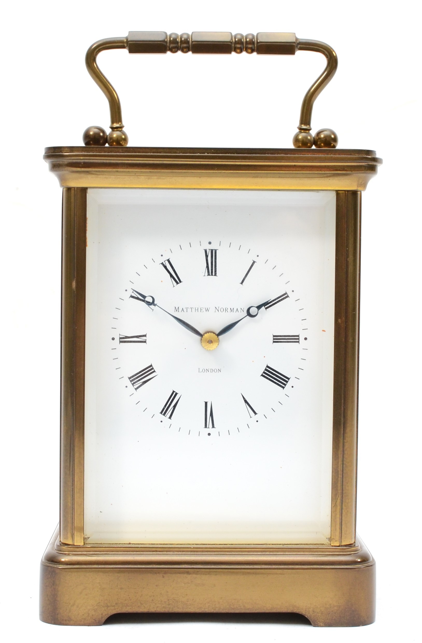 Matthew Norman of London, a 20th century brass corniche and four bevelled glass carriage clock, with