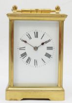 A late 19th/early 20th century French brass corniche cased repeating mantle clock, the white dial