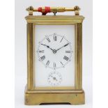 A late 19th century brass corniche cased and four glass repeat striking carriage clock, with swing