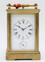 A late 19th century brass corniche cased and four glass repeat striking carriage clock, with swing