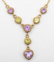 A 9ct gold peridot and amethyst necklace, 48cm, pendant 2cm drop, 2gm.