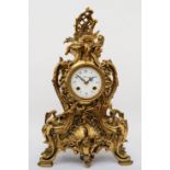 Korslant, a late 19th/early 20th century gilt brass cartouche shaped mantle clock, the white painted