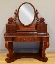 A late 19th century mahogany Dutch style dressing table, with an oval swing mirror flanked by two