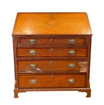 A 19th century inlaid oak fall front bureau, with four graduating drawers below with brass swing