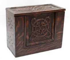 A 19th century carved oak box, with hinged fall front carved with Celtic knot and pokerwork