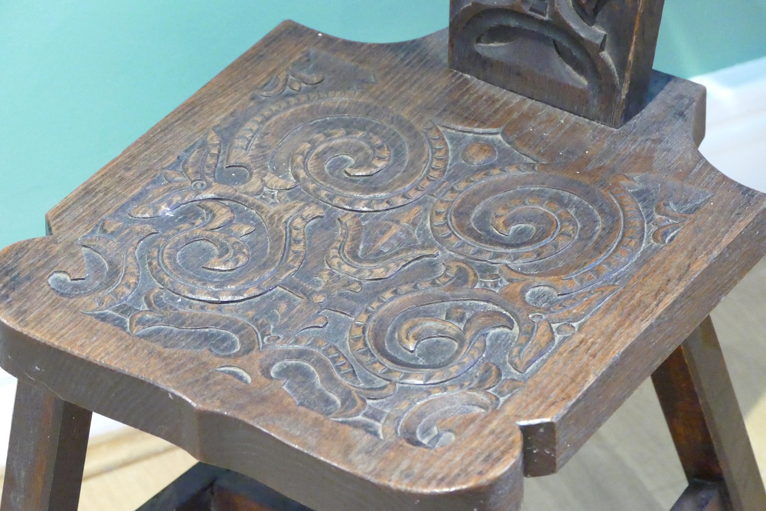 A late 19th century Welsh carved oak spinning chair, having carved floral decoration, raised on - Image 2 of 8